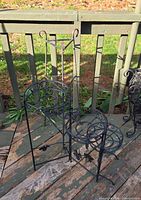 Two wrought iron plant stands on deck
