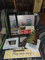 Overview of all plaques, frames, canvas art, angel figure and lampshade on sofa