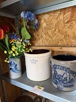 Shelf view of three stoneware crocks together