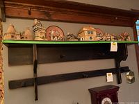 Front view of entire wooden wall shelf mounted on wall
