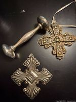 Three sterling pieces: two cross ornaments and rattle