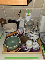 overview of tray containing assorted bowls, glass container, coaster rack and trinket box