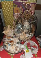 Overall view showing glass vase arrangement, conch shell, and cut glass bowl of shells