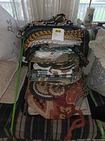 Stack of assorted textile pieces on couch