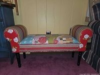 Full view of bench front showing patchwork upholstery and wood legs