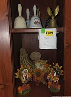 Shelf view showing bells on upper shelf and Thanksgiving decorations below