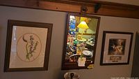 All three wall pieces: botanical print, wall mirror, Thomas Kinkade print