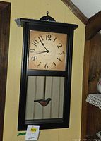 Full view of rectangular Thos. Walker wall clock hanging on wall