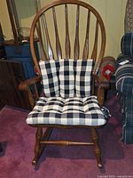 Front view of Village House wooden rocking chair with plaid cushions