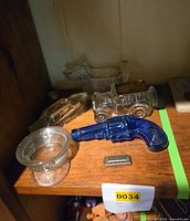 Shelf view with five glass candy containers