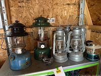 Group shot of all lanterns and reel on shelf