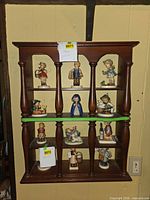 front view of wood wall shelf showing compartments and turned columns