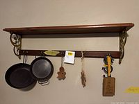Overall view of shelf, pans, ornaments, letter opener, plaque