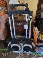 Cart folded showing wheels and handle