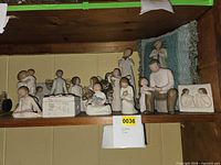 Front view of figurines, box, plaque and pillow on shelf