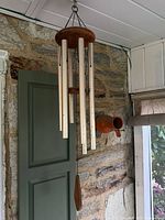 Full view Weatherland wind chime and partial pottery birdhouse background