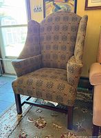 Front view of patterned wingback armchair