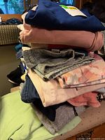Stack of folded women’s garments showing variety of colors and types