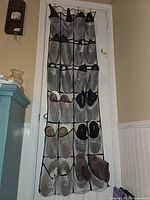 Full view of over-door organizer showing multiple pairs of shoes