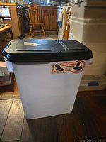 Front view of translucent rolling pet food container with black lid