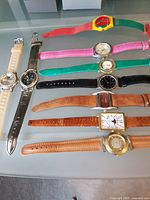 All ten watches laid out showing variety of bands and faces