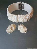 Bracelet open with matching earrings displayed