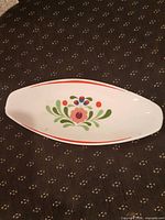 Top view of oval Hollóháza dish showing floral pattern and rim stripes