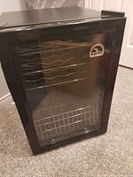 Front view of Igloo wine fridge showing glass door and black exterior