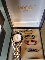 Watch in presentation box with four bezels visible