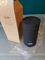 Diffuser standing beside original box, plastic protective sleeve visible