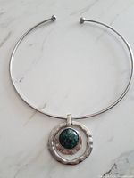 Full view of rigid collar necklace with pendant