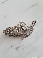 Full view of brooch front on marble surface