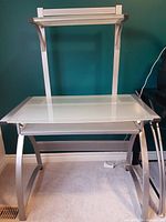 Front view showing full desk structure with shelves and frame