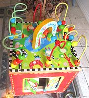 Oblique view of activity cube showing top bead mazes and side panels