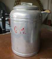 Front view showing red G.M. stencil, handle, lid knob