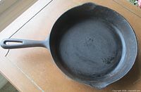 Top view of Findlay No. 8 cast iron skillet showing cooking surface, handle and pour spouts
