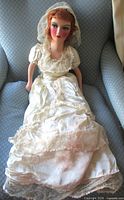 Full view of 30" boudoir doll in wedding gown on chair