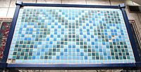 Top view of rectangular mosaic tile surface showing tile colors and missing tiles