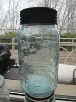 Front view of aqua Crown quart jar showing embossed crown and lettering