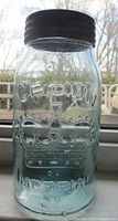 Front view of aqua glass jar showing Crown emblem and lettering