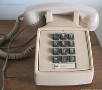 Front view showing telephone, handset on cradle, keypad visible