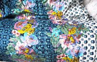 Roll of floral calico fabric showing pattern and color