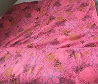 Overall view of folded pink floral rib knit fabric