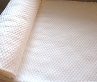 Rolled white quilted diamond pattern fabric
