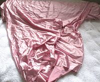 Overall view of the dusty pink shiny fabric spread out