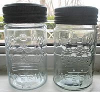 Front view of both jars showing embossing and lids