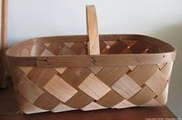 Side view of rectangular split-oak basket, showing weave pattern and handle