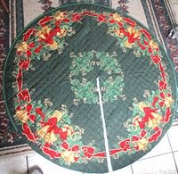 Full view of round quilted tree skirt showing motif and quilting