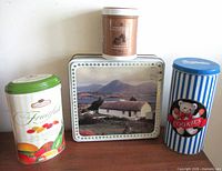 Group shot of four advertising tins