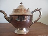 Right side profile showing full teapot, handle, spout, foot, lid